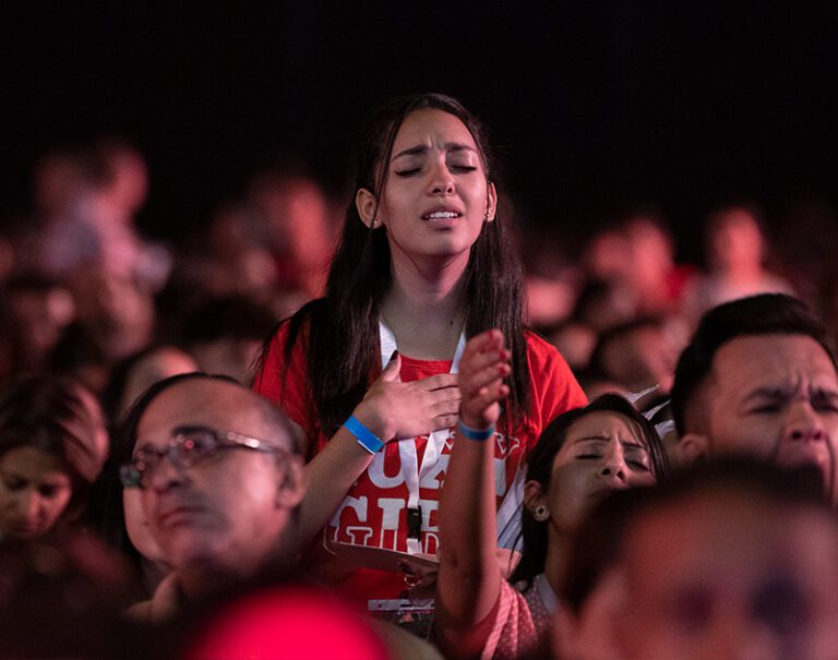 Young Egyptian Christian Woman worshipping in Christian Evangelistic Event in Egypt