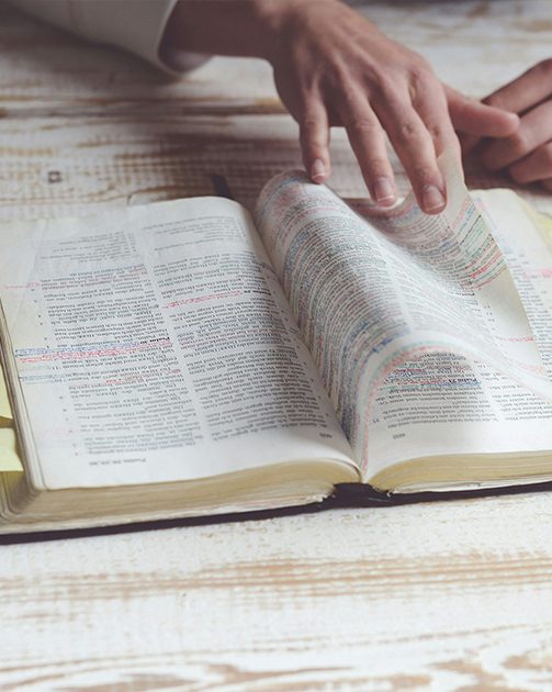 close up of a Bible with the page being turned