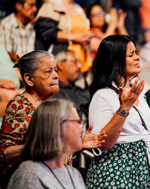 close up of two engaged women at a worship church service