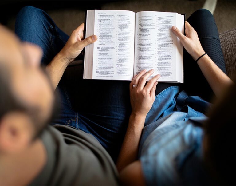 overhead shot of a man and woman reading the same Bible