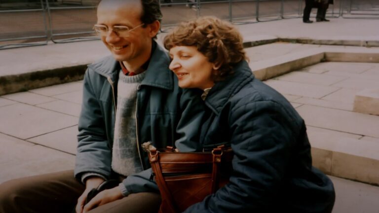 A man and woman face slightly away from camera