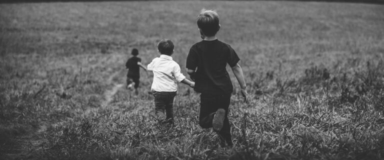 Children run through a field