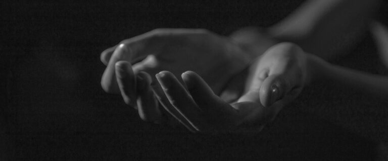 Black and white image of open hands